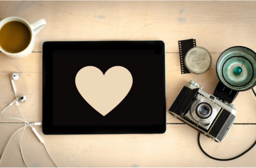 A heart-shaped paper on top of a wooden table