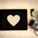 A heart-shaped paper on top of a wooden table