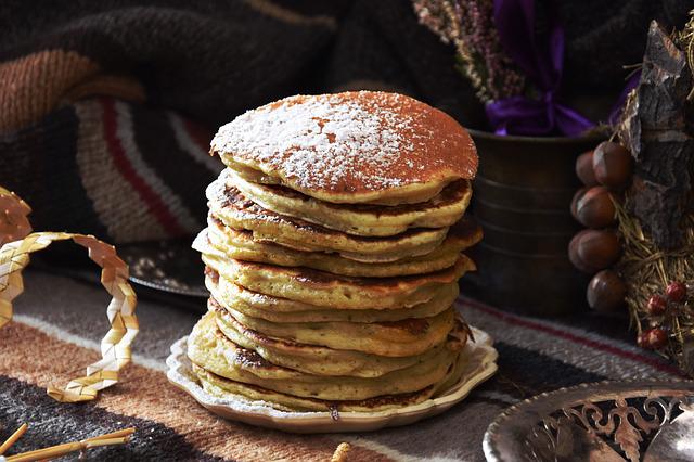 A tower of pancakes with sugar powder